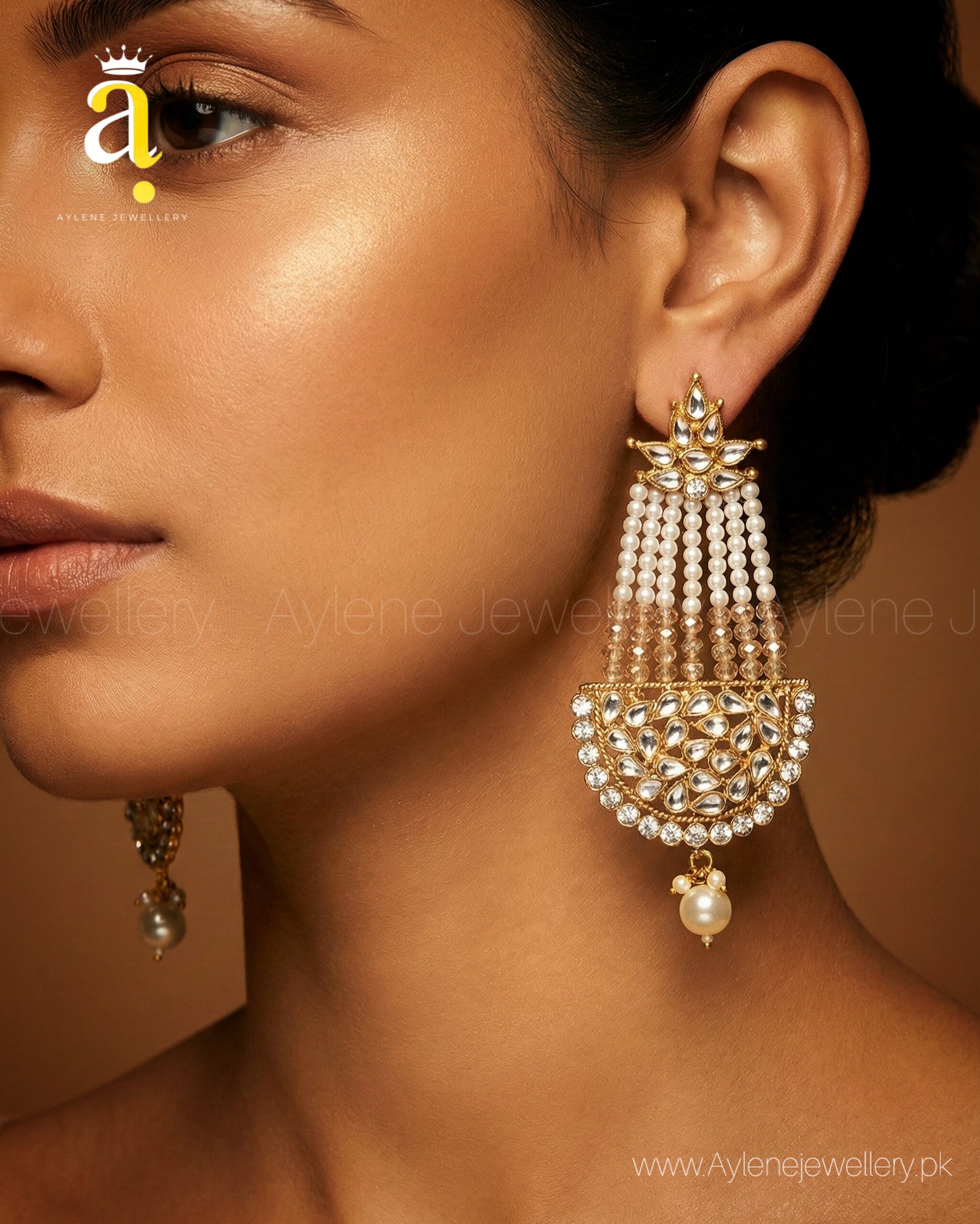 Close-up of a woman wearing a gold and pearl earring with Aylene Jewellery logo.