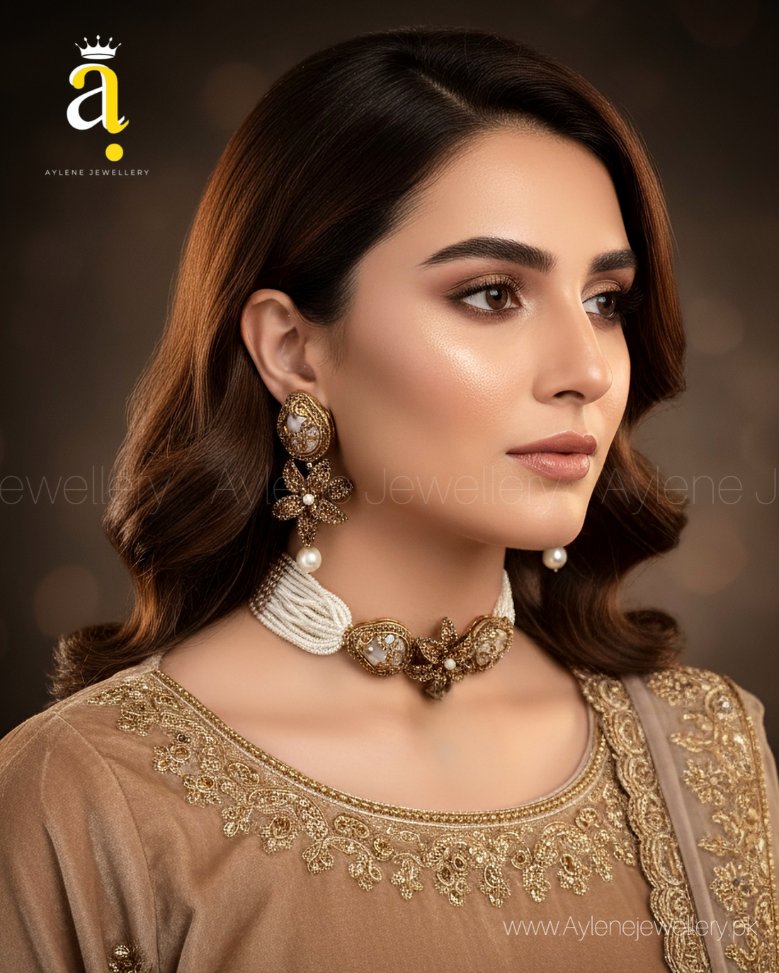 Jewelry set with earrings and a necklace on a marble surface with a beige fabric background.